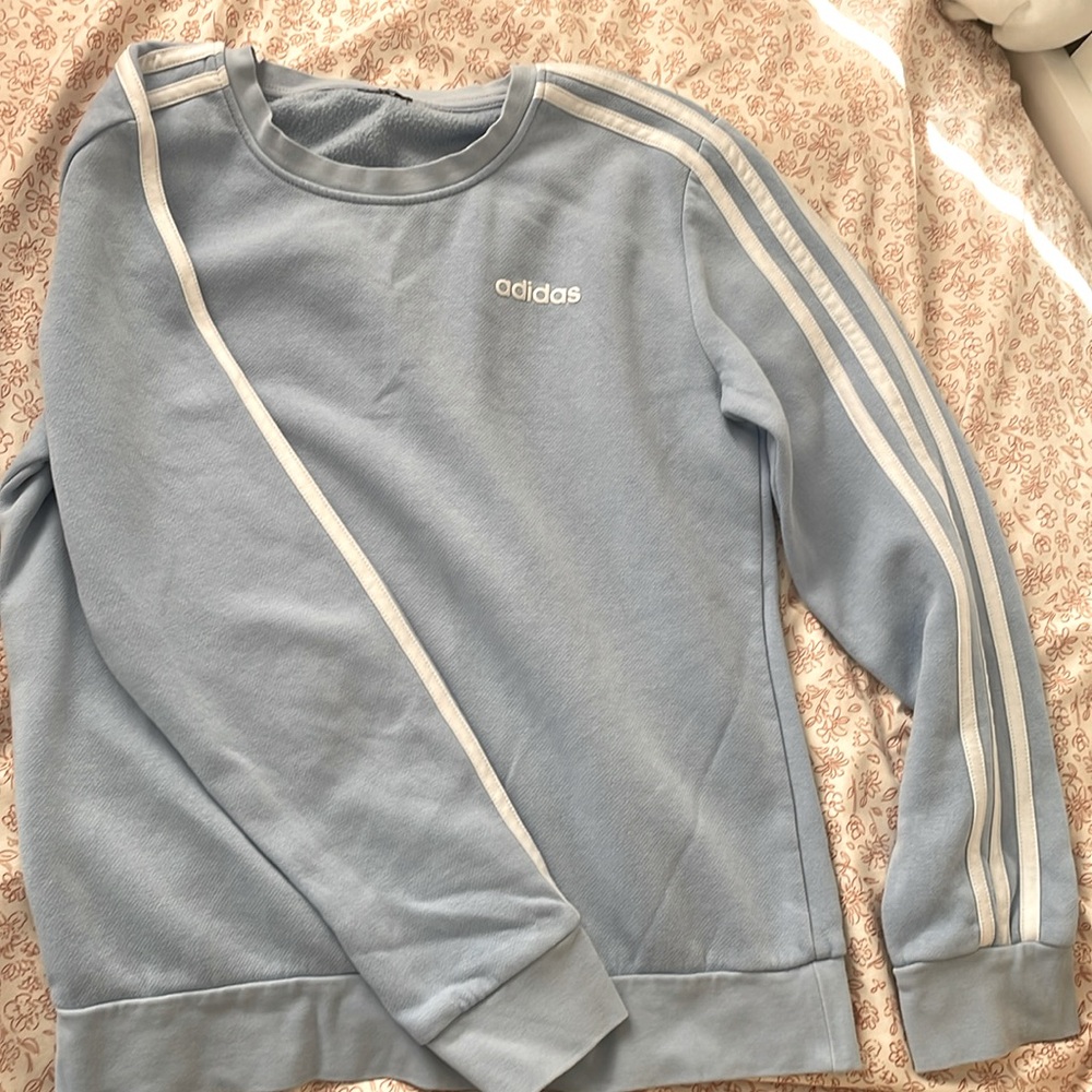 Small, light blue, no design on back adidas sweat shirt.